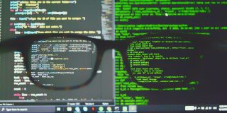 iPhone spyware company NSO must reveal code | Code on monitor viewed through glasses