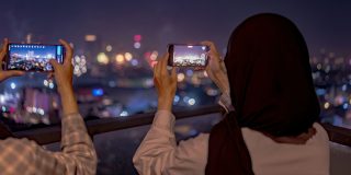 A billion dollars later, the iPhone 16 is still banned in Indonesia | People using older smartphones to photograph the Jakarta skyline