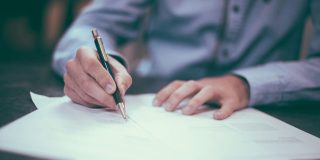 For $5, Adobe's Acrobat AI assistant will check your contracts for you | Close-up of man signing contract