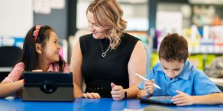 Nine states proposing to make Apple and Google app stores responsible for age verification | Two kids and an adult using iPads
