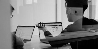 Chipmakers discuss Trump attack on the CHIPS Act | Two people in an animated discussion in a meeting room