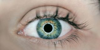 Fall Detection could be coming to Vision Pro, Apple Glasses, and even smart contact lenses | Close up of lens with lights seen in pupil
