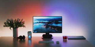 US Mac growth suggests Microsoft may have done Apple a huge favor | MacBook desk setup with colorful Hue lighting
