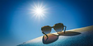 Apple smart glasses only make sense if two things are true | Sunglasses resting on a pair of jeans shot into the light