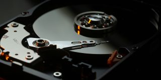 Apple logins with plain text passwords found in massive database of 184M records | Close-up photo of the inside of a hard drive