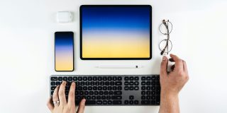 Nomad eSIM is the perfect travel companion for your eSIM iPad | iPad and other Apple devices on a white table