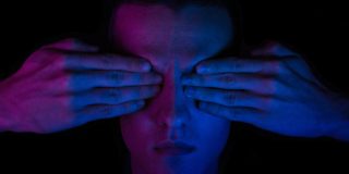 US government seeks tool to find 'hidden language' in messages on your phone | Low-key colorful photo shows hands over eyes