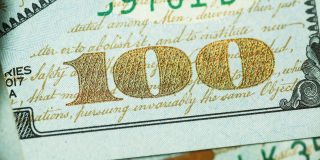 Paid subreddits plan on hold as company prioritizes search engine plans | Close-up of $100 bill