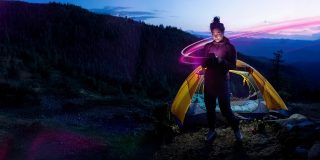 These six iPhone apps work via T-Satellite | Woman using her phone in the wilderness