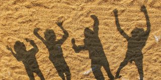 Apple will have to comply with another App Store age verification law, in California | Shadows of children seen on sand