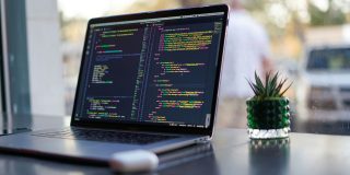 Coding assistance websites exposed credentials for banks, government agencies, and more | Website code shown on a MacBook screen