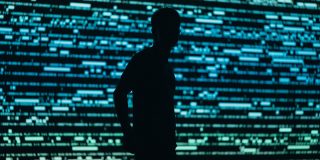 India orders Apple to pre-instal an undeletable state security app on iPhones | Photo shows the silhouette of a person against a background representing data