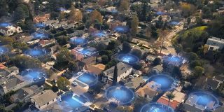 Tone-deaf Ring Search Party feature sparks public backlash | Image shows an aerial view of a residential neighborhood with blue circles activated