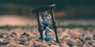 iCloud really needs to copy Dropbox 'sync next' | Photo of an hourglass with blue sand