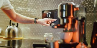 Ikea smart home failings point to a problem with the Matter standard | Stock photo of someone using a touchscreen in a kitchen next to a coffee machine
