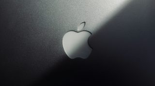 top of a MacBook lid showing the Apple logo