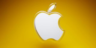 Analysts believe Apple taking a highly unusual step to double Mac user base | Render of an acrylic Apple logo against a vibrant yellow-orange background