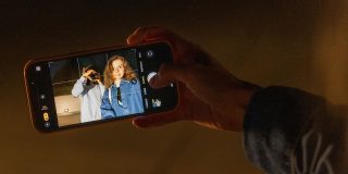 This could be the best thing to ever happen to Apple's Camera app | Image shows someone taking a photo on an iPhone with controls visible on the screen