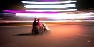 iPhone thieves can get up to $800 more if they snatch unlocked devices | Blurred photograph of two people riding a scooter