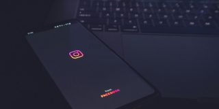Hackers tricked Meta AI into letting them take over high-profile accounts | Low key photo shows the app opening on a smartphone placed on top of a MacBook keyboard