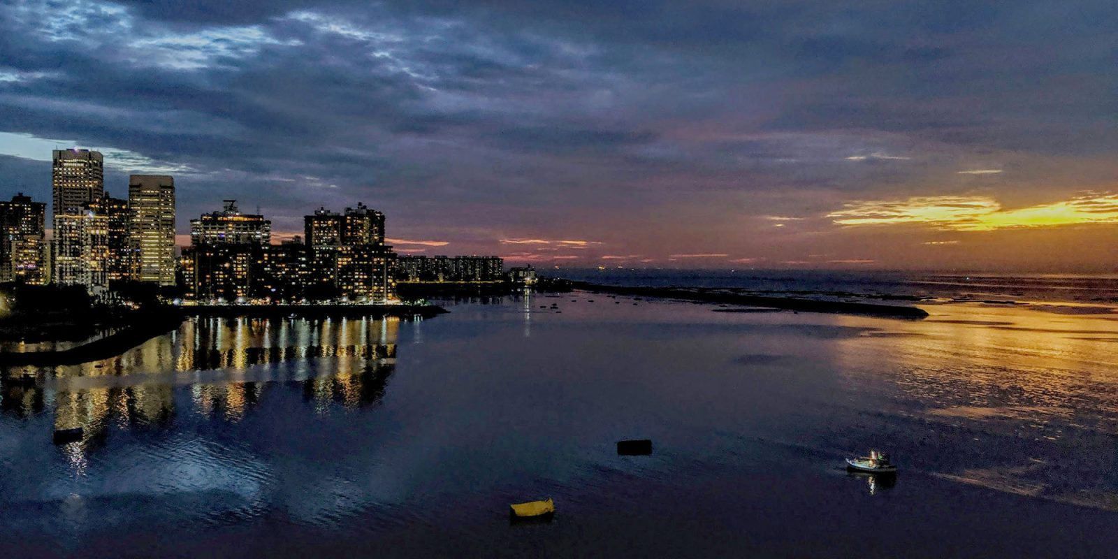 Discriminatory job ads for iPhone workers ended after Reuters report | View of Mumbai waterfront at sunset