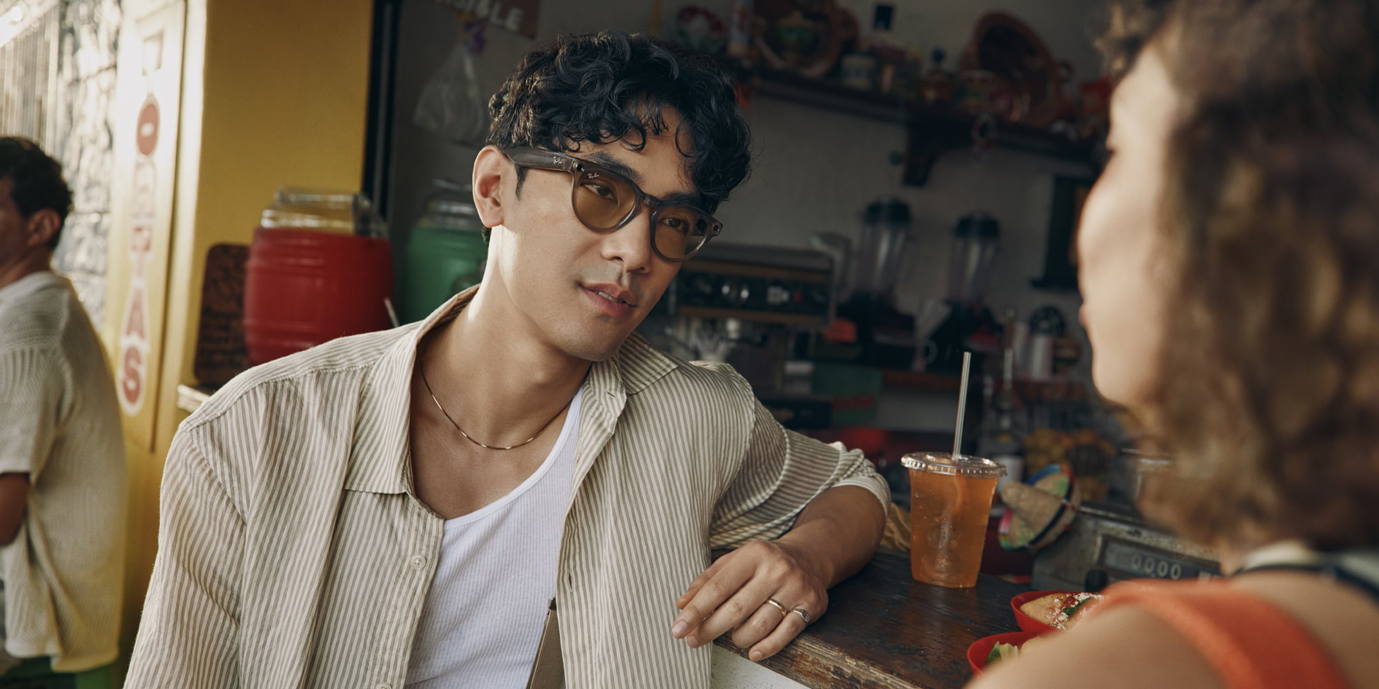 Live translation available to all in Ray-Ban Meta glasses | Man wearing the glasses having a conversation in a cafe