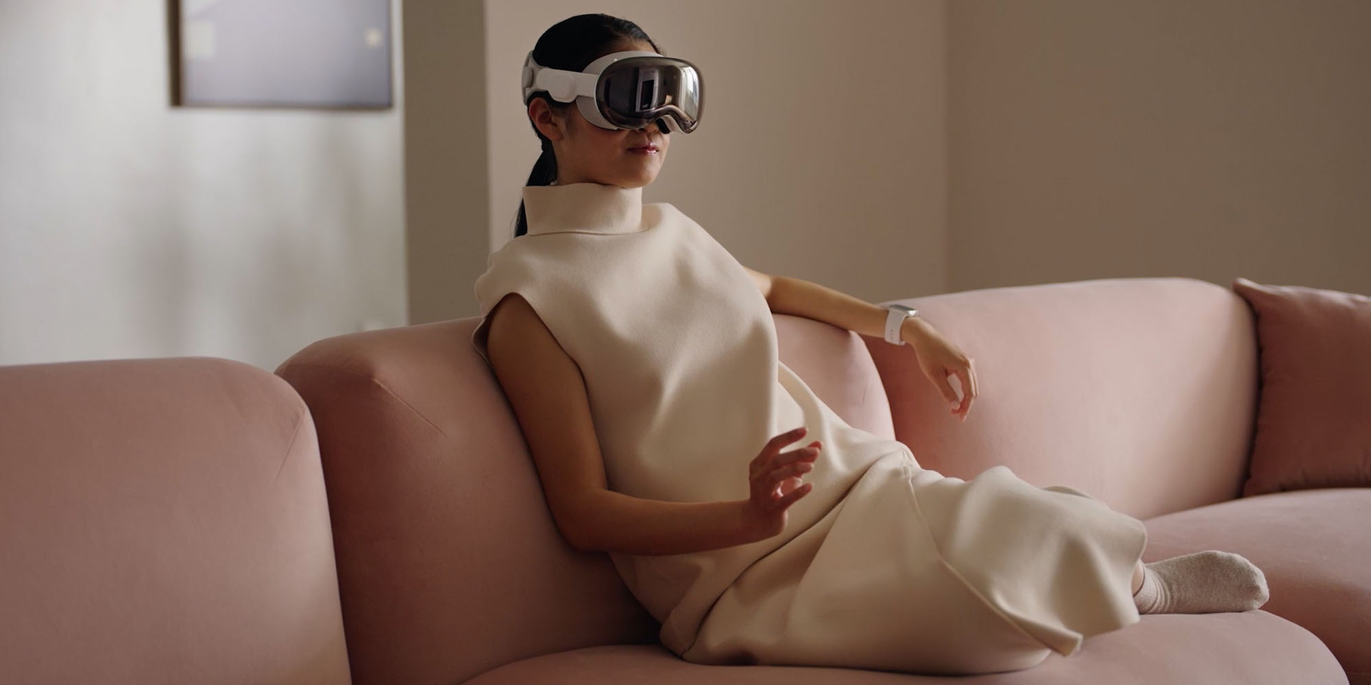 Sketchy rumor suggests Apple Glasses will support Vision Pro-style hand gestures | Photo shows a woman using a hand gesture while wearing Vision Pro