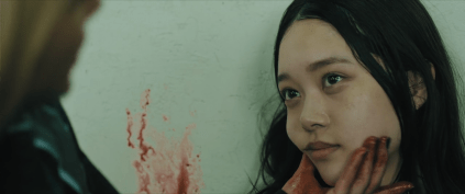 Mahiro wiping blood from Chisato's cheek in Baby Assassins 2: Babies.