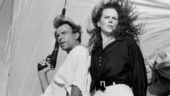 Actor Sam Neill and Actress Nicole Kidman on the set of the Warner Bros movie "Dead Calm" circa 1989. He is holding a gun