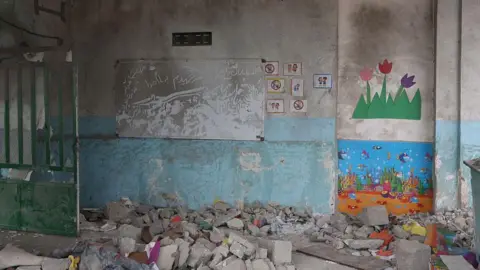 Anadolu via Getty Images Images from the scene show bombed out classrooms covered in rubble. 