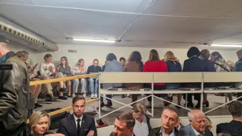 Reuters People gather inside a shelter at the Lithuanian parliament after an 'air danger' warning.