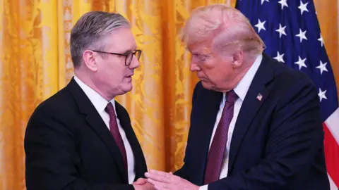 Getty Images UK Prime Minister Keir Starmer and US President Donald Trump shake hands at a joint press conference in the East Room at the White House in February 2025