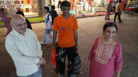 Chitral Khambhati/ BBC Jatinder and Anita Sabharwal with their CarryMen assistant Anand Kumar