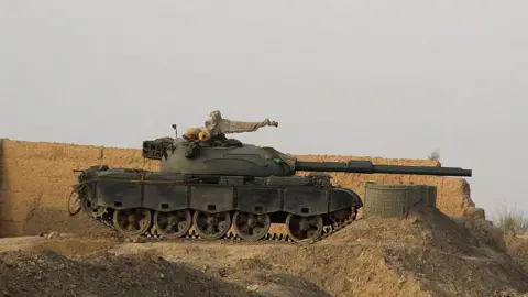 AFP via Getty Images A tank near a wall along the border in Chaman, Pakistan.
