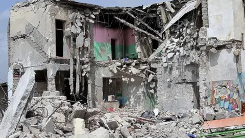 Anadolu via Getty Images The partially destroyed primary school at Minab, Iran