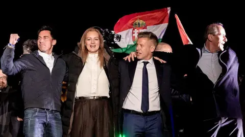 NurPhoto via Getty Images Members of Hungary's ruling party Tisza celebrate their landslide win in the Hungarian nationwide elections with newly elected Prime Minister Peter Magyar in Budapest, Hungary, on April 12, 2026