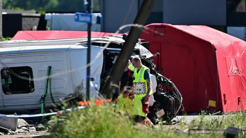 Belga/AFP Emergency services pictured at the scene of an accident between a train and a minivan, at the railway crossing Vierhuizen, in Buggenhout, Tuesday 26 May 2026