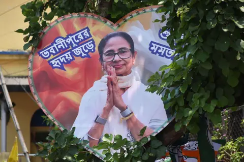 NurPhoto via Getty Images A cutout of former Chief Minister of West Bengal, Mamata Banerjee, is seen on a tree in Kolkata, India, on May 4, 2026
