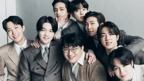 Bang Si-hyuk's Instagram Bang Si-hyuk (centre) and K-pop group BTS