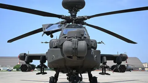 Getty Images File image of an AH-64 Apache helicopter in a stationary position ahead of a US military parade