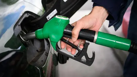 Getty Images A person fills up their car with a petrol pump. 
