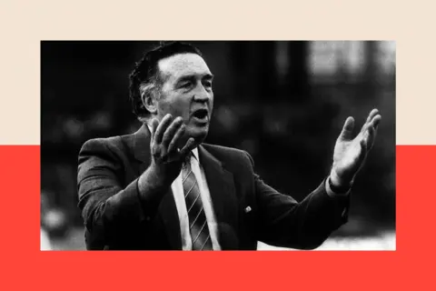 Daily Mirror/ Getty Images A black and white photo of Jock Stein with his hands raised
