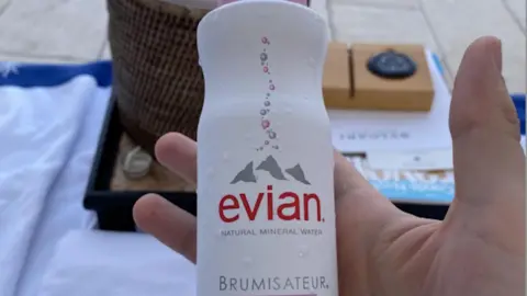 Police of Finland Kivimaki holding a bottle of water