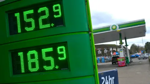Getty Images Petrol prices displayed on a digital sign outside a BP petrol station in Guildford.