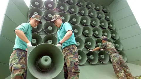 KIM JAE-HWAN/AFP via Getty Images South Korean soldier in front of loudspeakers along the border with North Korea in Paju on 16 June 2004 