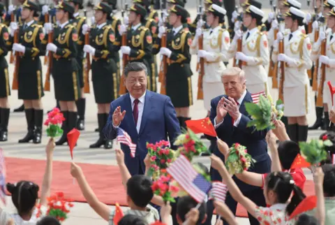 Reuters Chinese President Xi Jinping and U.S. President Donald Trump attend a welcome ceremony at the Great Hall of the People, in Beijing, China May 14, 2026