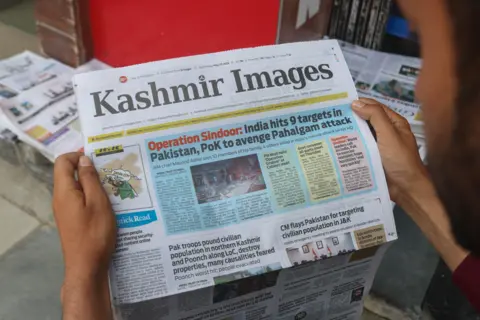 NurPhoto via Getty Images A man reads a newspaper with the front-page news of ''Operation Sindoor'' in Srinagar, Jammu and Kashmir, on May 8, 2025. 