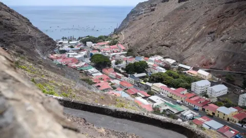 Getty Images A view from above of several dozen houses in Jamestown, which are situated within a valley on St Helena