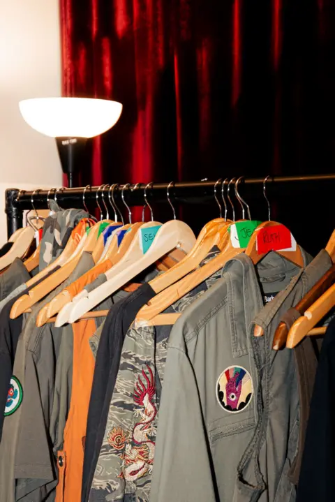 Blair Brown A clothing rack showing stage costumes for the Gorillaz stadium show