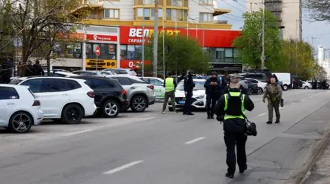 Reuters Police work at the site of a shooting incident in Kyiv